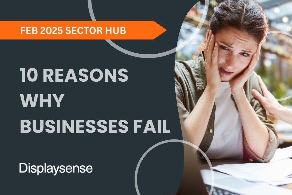 February 2025 Sector Hub by Displaysense outlining 10 reasons why businesses fail, featuring a stressed entrepreneur surrounded by paperwork and a laptop in a workspace setting.
