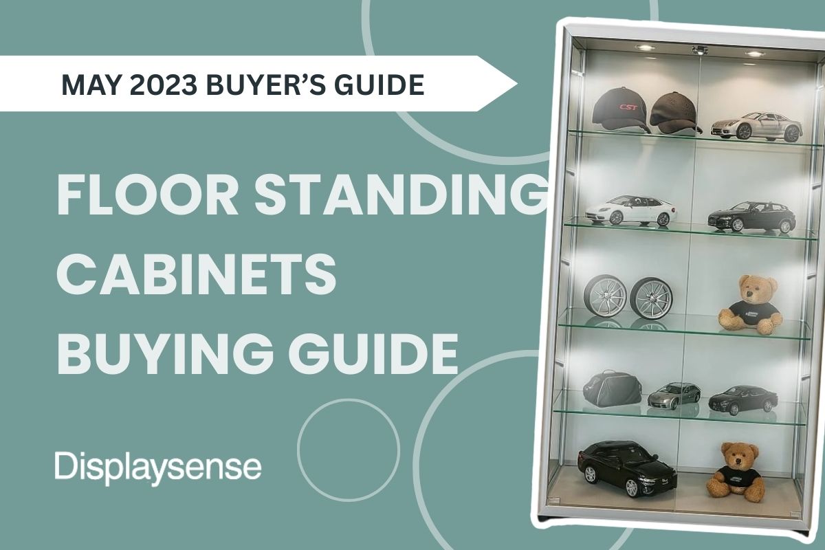 May 2023 Buyer’s Guide by Displaysense featuring a floor standing display cabinet with LED lighting, glass shelves, and collectible items like model cars, hats, and teddy bears.