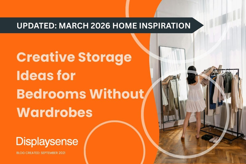 A woman in a white dress browses garments on a black commercial clothes rail next to a floor-length mirror in a bright bedroom with parquet flooring — featured image for the Displaysense guide to creative storage ideas for bedrooms without wardrobes