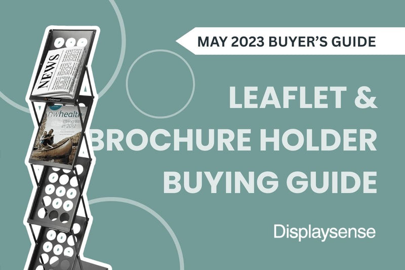 May 2023 Buyer’s Guide by Displaysense featuring a leaflet and brochure holder buying guide, with a zigzag-style freestanding literature stand displaying newspapers and promotional brochures.