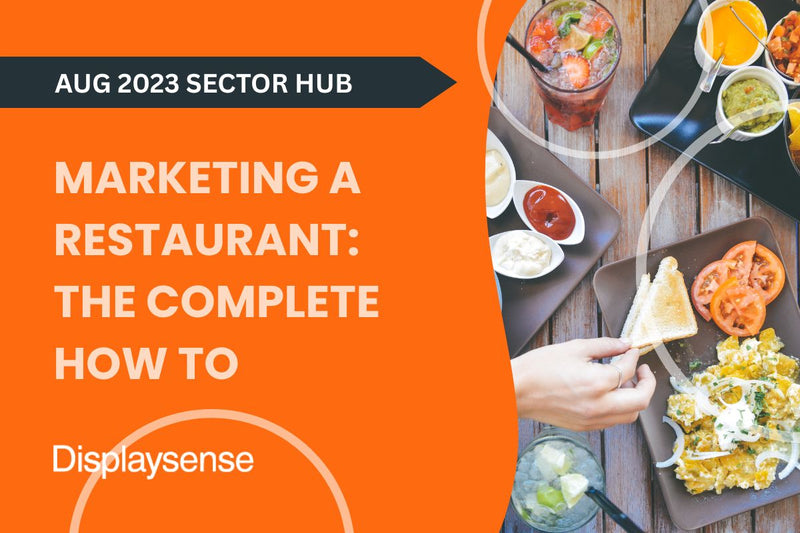 August 2023 Sector Hub by Displaysense covering how to market a restaurant, featuring a vibrant overhead view of shared plates, dips, and drinks with a diner reaching for food in a lively dining setting.