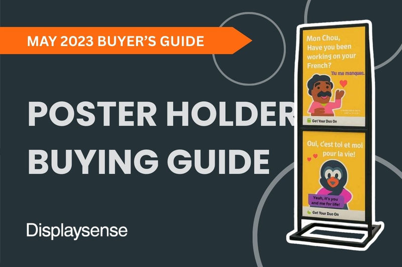 May 2023 Buyer’s Guide by Displaysense highlighting poster holder options, featuring a freestanding double-sided floor poster stand with vibrant educational posters designed for public or retail spaces.