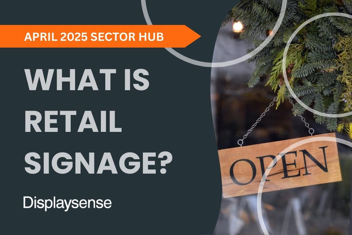 April 2025 Sector Hub by Displaysense answering “What is retail signage?”, featuring a rustic wooden open sign hanging in a shop window with festive greenery in the background.