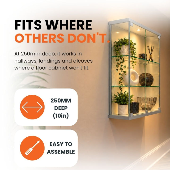 Angled view of the illuminated silver wall display cabinet highlighting its slim 250mm depth for hallways, landings and other compact spaces.