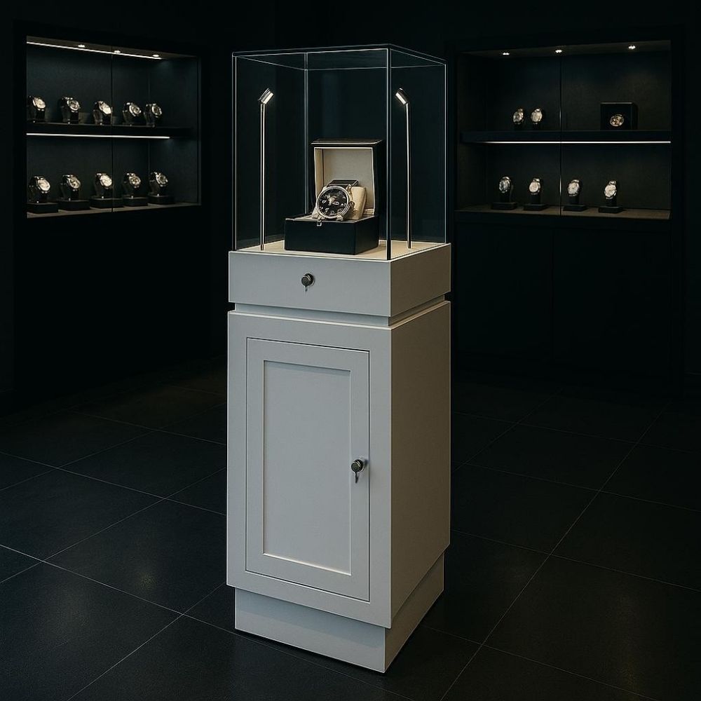 A stylish white lockable wooden display plinth, featuring 2 LED lights, a hidden drawer, and an internal shelf. Designed with a sturdy aluminium frame and toughened safety glass for durability and elegance. Ideal for showcasing valuable collectables or retail products in shops, exhibitions, or home displays. Measuring 1500mm high, this fully assembled unit offers secure storage and a sleek, modern aesthetic.