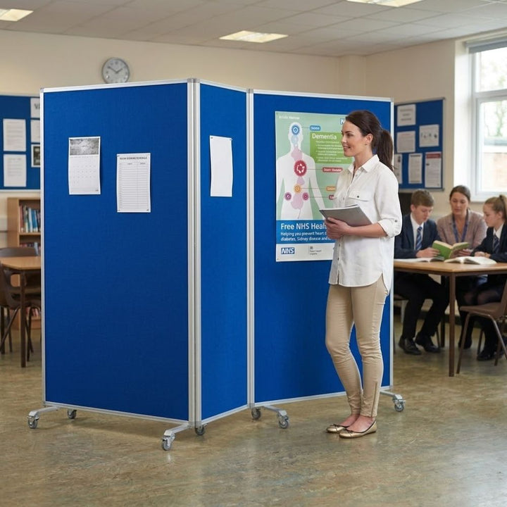 Double-sided mobile noticeboard with three blue felt panels and a durable aluminium frame, measuring 3600 x 1900mm. Designed for partitioning and display, it features locking castors for secure and easy movement, ideal for offices, schools, and exhibitions.