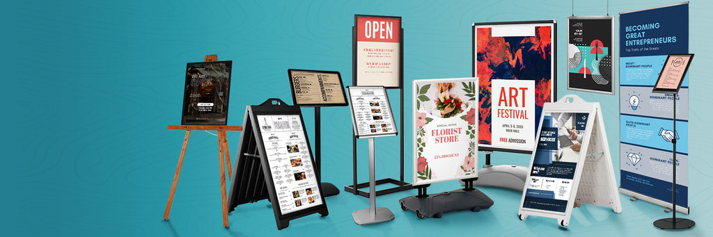 selection of sign holders, pavement signs and banner stands against green background