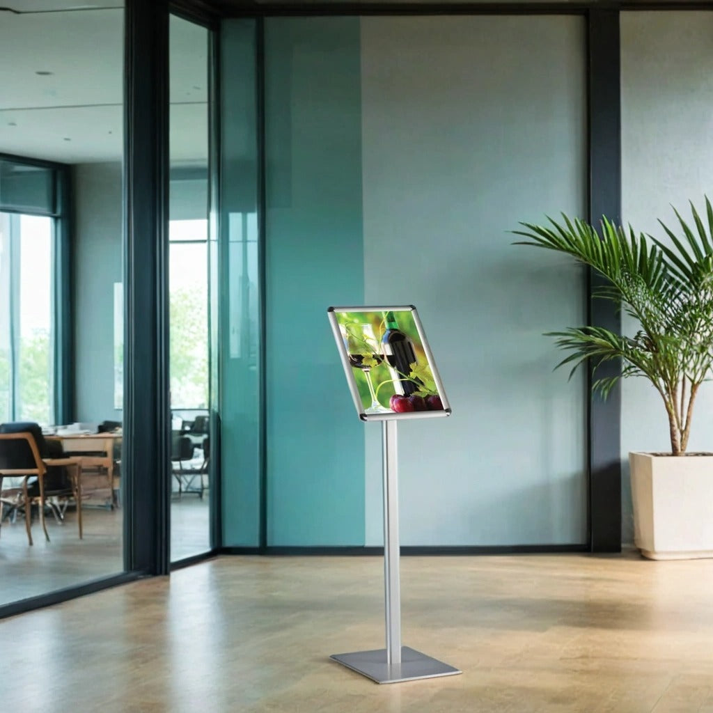 A sleek silver A4 free-standing snap frame display stand with an adjustable orientation, measuring 1000mm high and 250mm wide. Ideal for professional signage and informational displays.