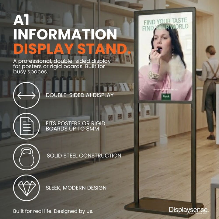 Black A1 double-sided information display stand in a retail setting, designed for posters or rigid boards up to 8mm thick with solid steel construction.