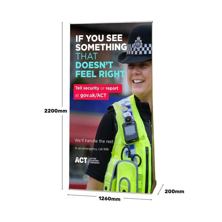 ACT awareness banner showing product dimensions of a large-format roller banner with a visible campaign slogan for counter-terrorism reporting.
