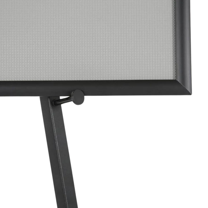 Close-up of the black easel's adjustable arm and thumbscrew securing an A1 snap frame poster at the chosen viewing height