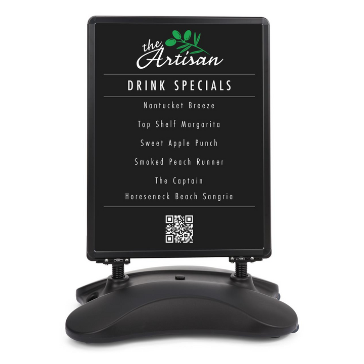 Front-on cut-out of a black A0 wind-resistant pavement sign, drinks specials menu in the snap frame, spring mounts and water-fill base on white.
