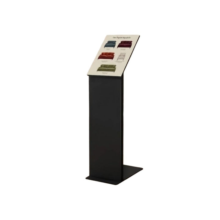 Black aluminium alloy totem on a solid steel base, holding a frameless A4 acrylic panel at an angled reading position for retail and reception use.
