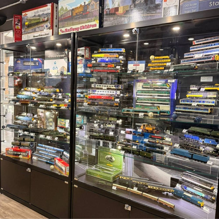 Black glass model train display cabinets with locomotives and carriages