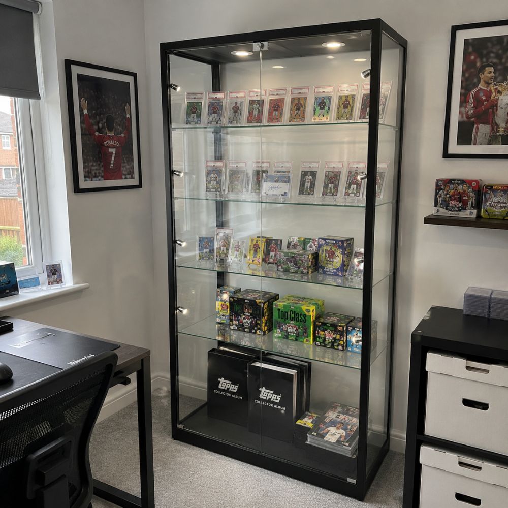 Black glass trading card display cabinet with graded football cards