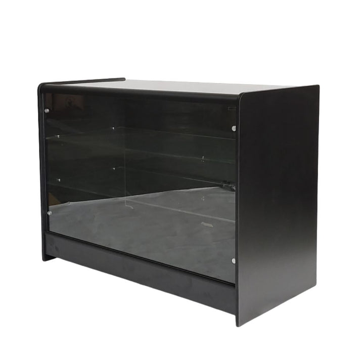 Angled product view of a black wooden glass retail display counter with glazed front, internal display shelves, solid side panels and a freestanding structure, designed for presenting accessories, collectables, electronics, gifts and high-value merchandise in retail stores.