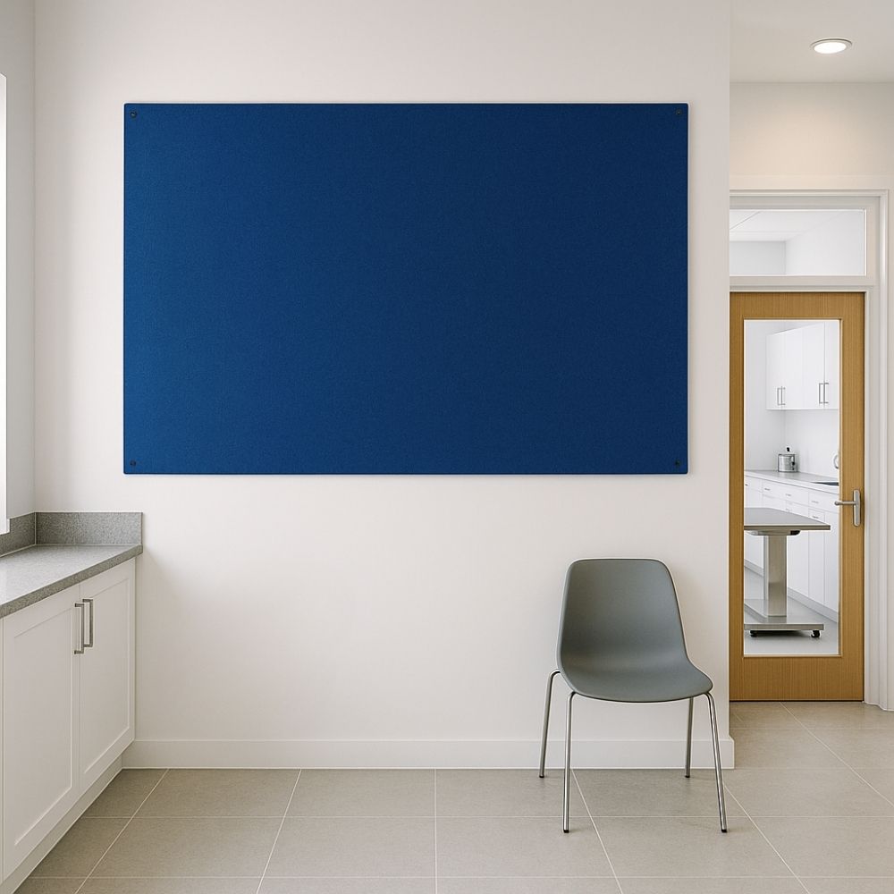 Blue felt pinboard mounted on the wall of a clean, modern medical waiting room with tiled flooring, white cabinetry, a single grey chair, and a wooden door revealing a clinical space beyond.