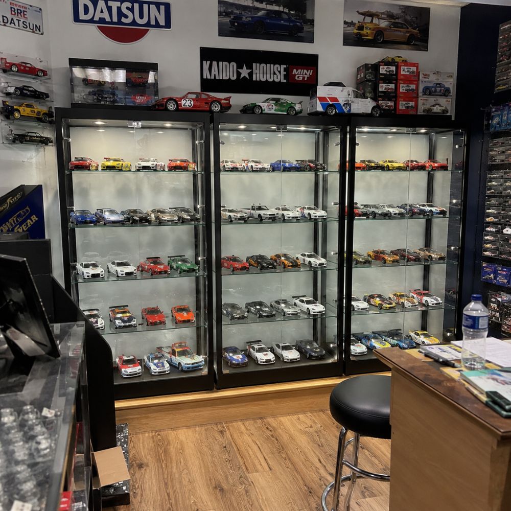 Diecast model car collection displayed in lit glass Displaysense cabinets