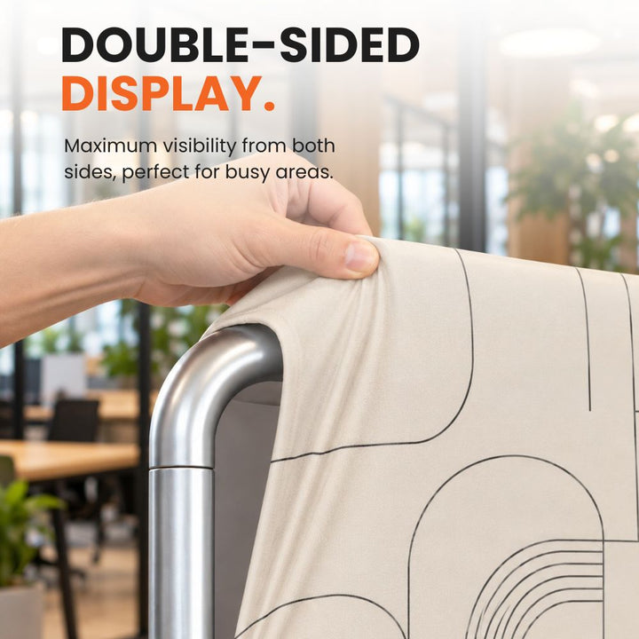 Close-up of printed stretch fabric being pulled over the rounded aluminium frame to illustrate the double-sided backdrop construction.