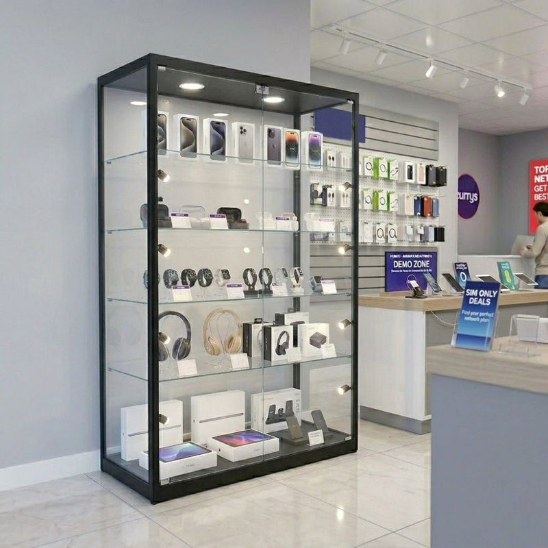 Smartphones, smartwatches, headphones and tablets sit across five lit levels of a black glass cabinet on an electronics shop floor behind lockable doors.
