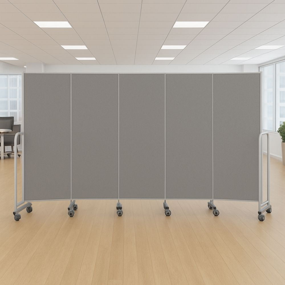 Five-panel grey fabric room divider with silver frame and lockable castor wheels, fully extended in a spacious modern office with wood flooring, ceiling lights, and desks in the background.
