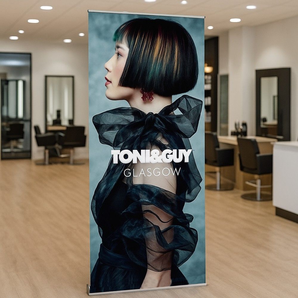 Freestanding roll-up banner advertising Toni & Guy Glasgow inside a hair salon, ideal for salon promotions and stylish interior branding.

