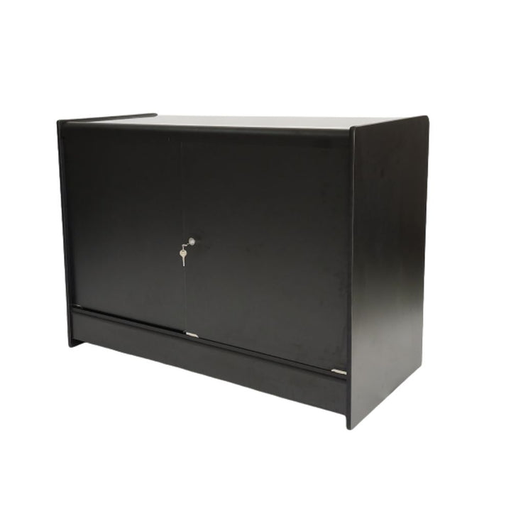 Rear view of a black wood and glass retail counter showing solid lockable storage doors with key access, ideal for keeping stock, packaging, till supplies and valuable retail items secure behind the customer-facing display showcase.
