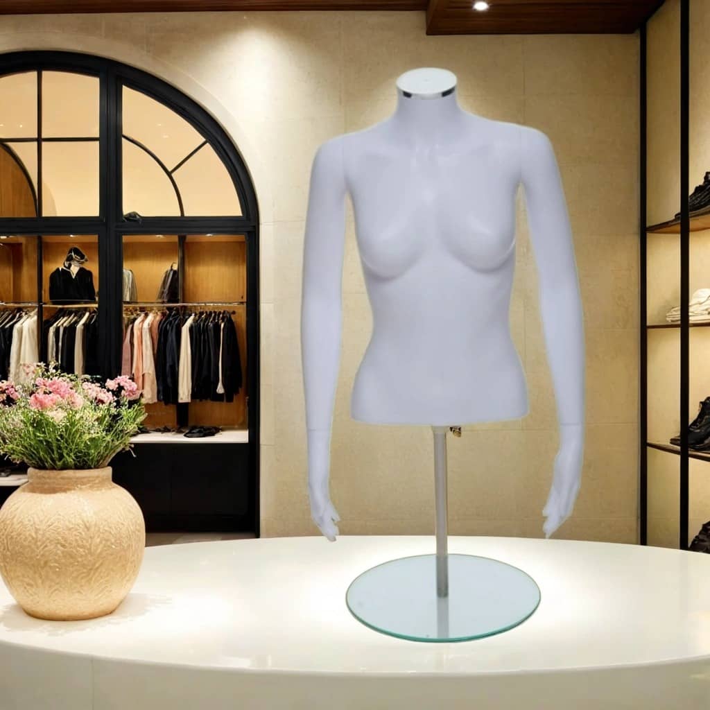 Matt white female torso mannequin with arms and stand displayed in a modern clothing boutique, perfect for retail fashion displays and visual merchandising.