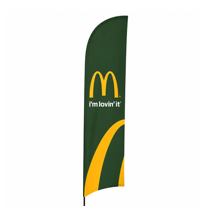 Green McDonald’s promotional feather flag banner with yellow logo and slogan on a freestanding outdoor display pole.