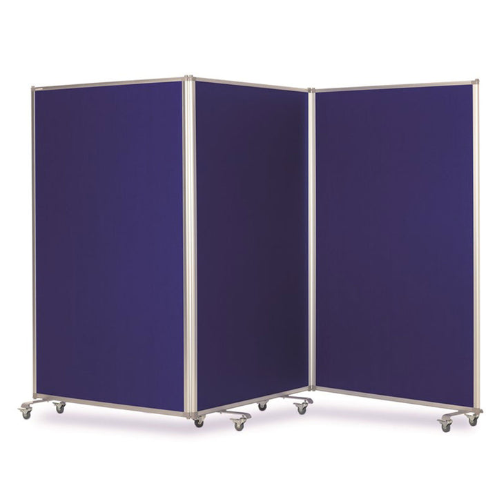 Blue felt mobile partition screen with three hinged panels folded into a zigzag on castors, dividing an open space into separate working areas.