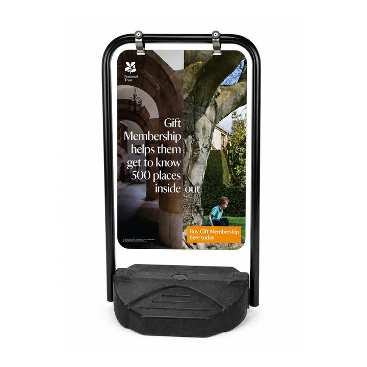 Outdoor pavement swing sign displaying National Trust membership advertisement with heritage property and family lifestyle imagery.