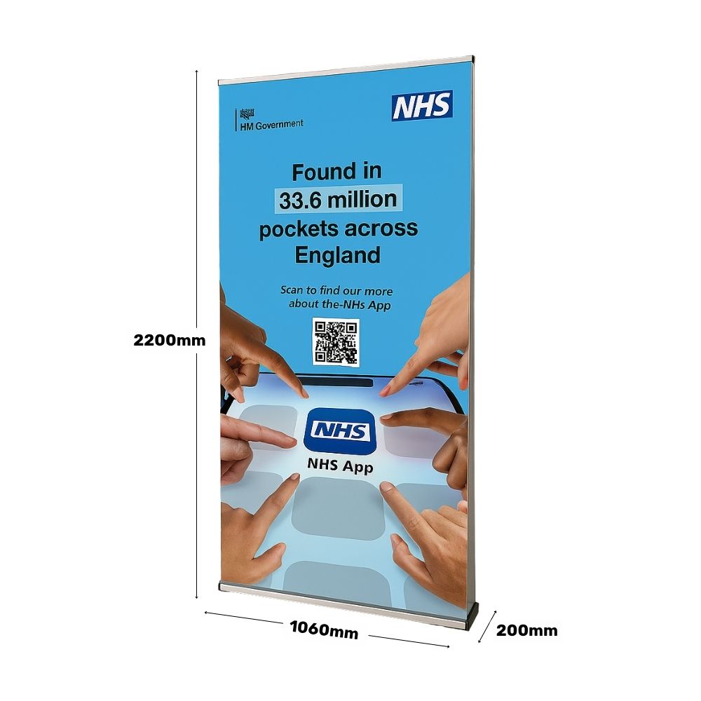 Size guide for NHS App roller banner showing height of 2200mm and width of 1060mm, featuring diverse hand graphics pointing to the NHS app icon.