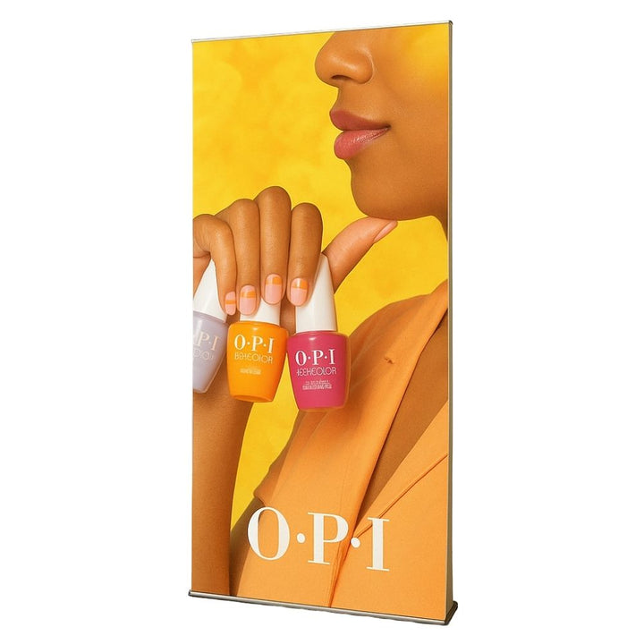 Close-up view of a portable roll-up banner featuring OPI nail polish products, showcasing vibrant colour marketing in salon environments.