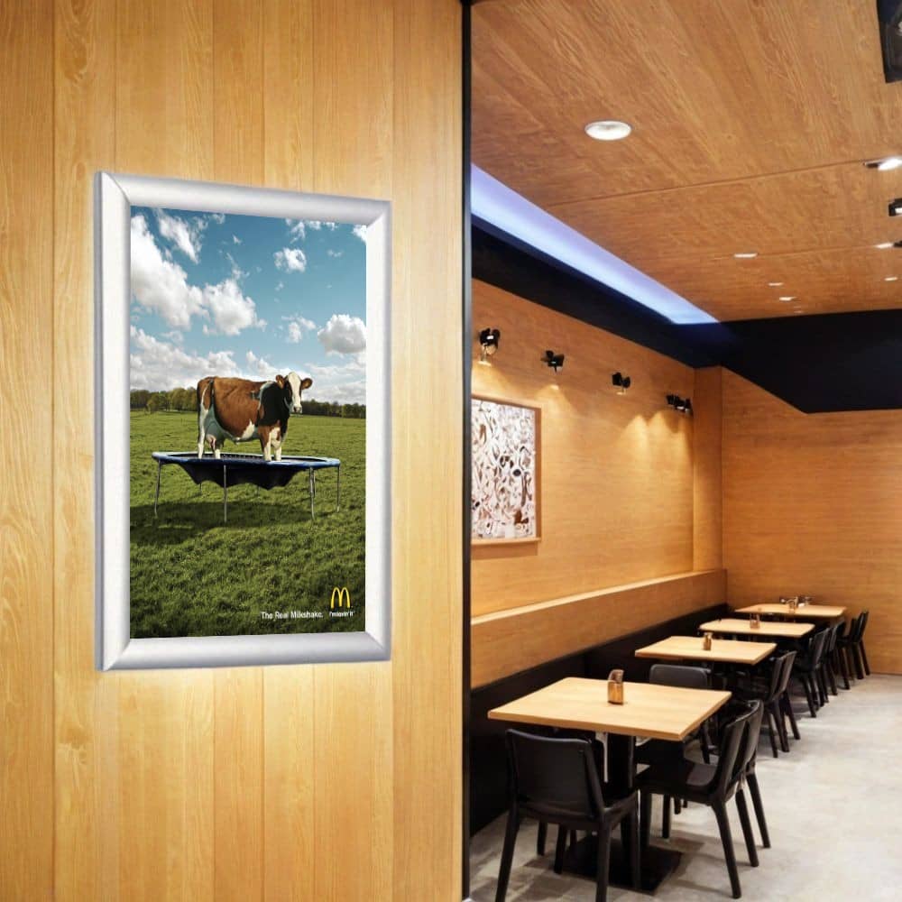 Set of 10 A2 silver poster snap frames with a sleek 25mm mitred frame and included wall fixings for secure mounting.
