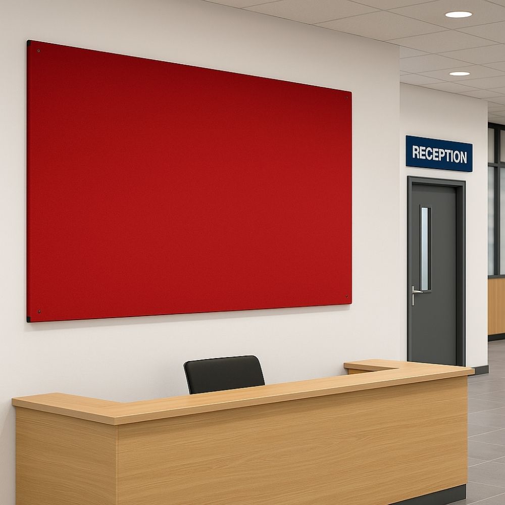 Bright red fabric noticeboard fixed above a wooden reception desk with a black chair, located in a modern office lobby with tiled flooring and a visible reception sign.