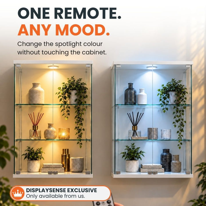 Two white glass display cabinets demonstrate warm and cool lighting from the integrated colour-changing LED spotlight controlled by remote.
