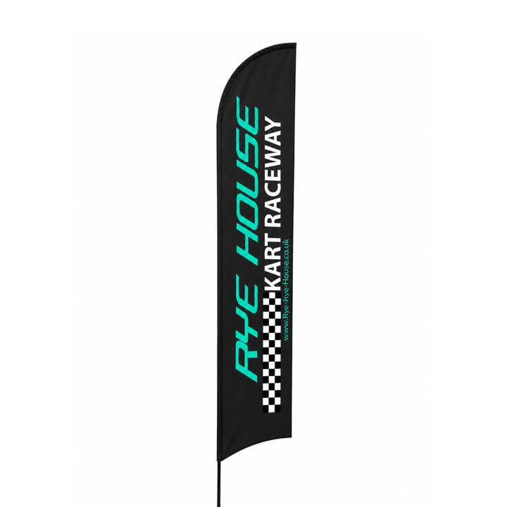 Black Rye House Kart Raceway feather flag banner with teal and white branding displayed on a spike base beside an outdoor UK kart racing circuit.