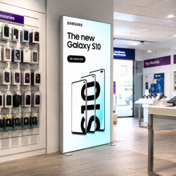 Samsung Galaxy S10 LED lightbox display installed in a mobile phone retail store with illuminated smartphone advertising graphics.