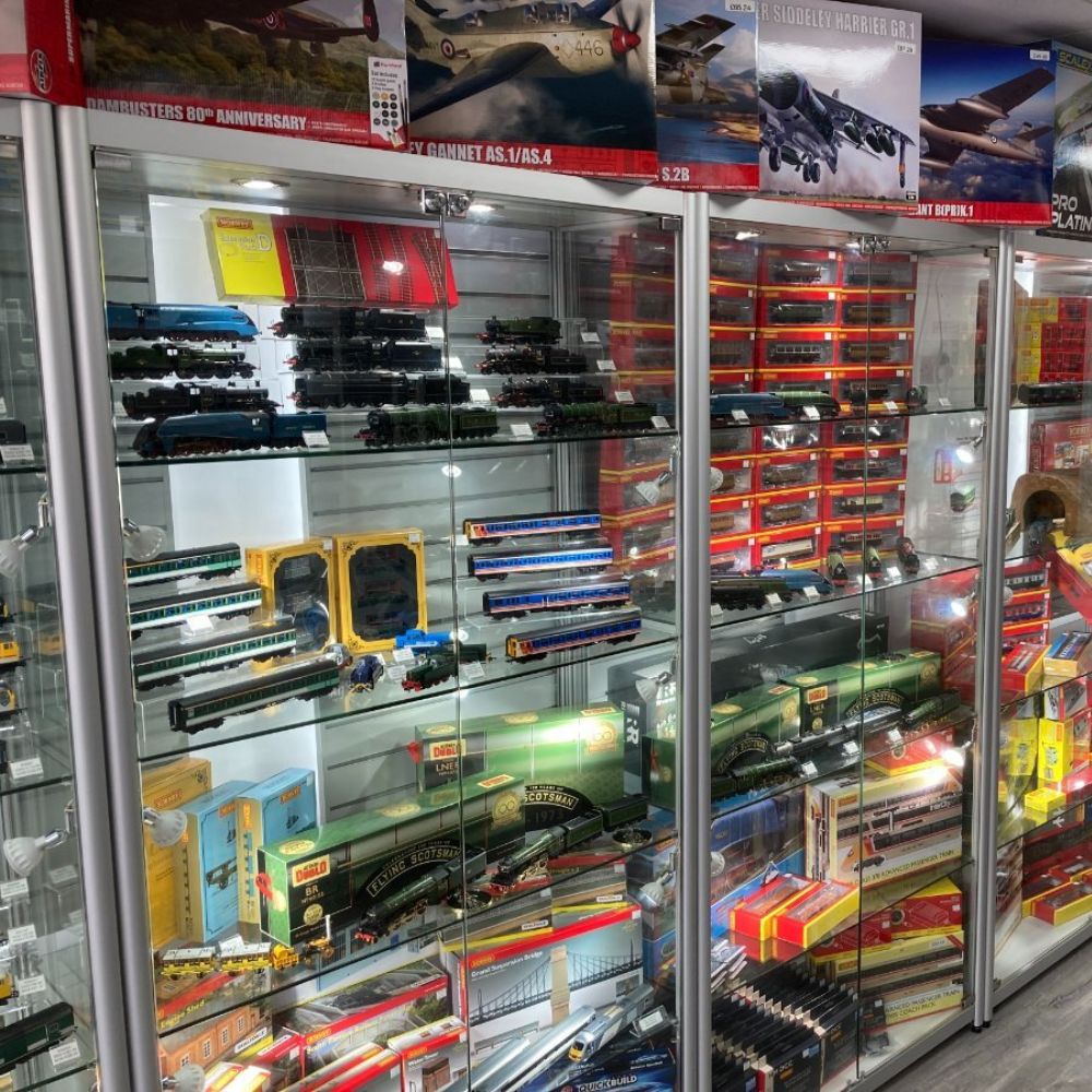 Silver glass model train display cabinets with boxed railway collectables