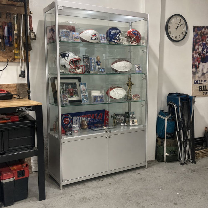 Silver glass sports memorabilia display cabinet with signed American footballs