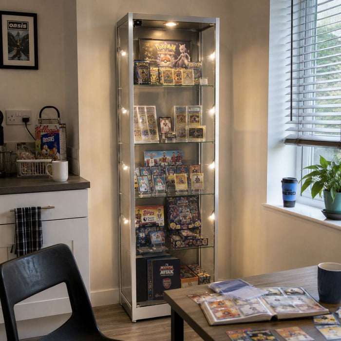 Silver illuminated trading card display cabinet with Pokémon and football cards