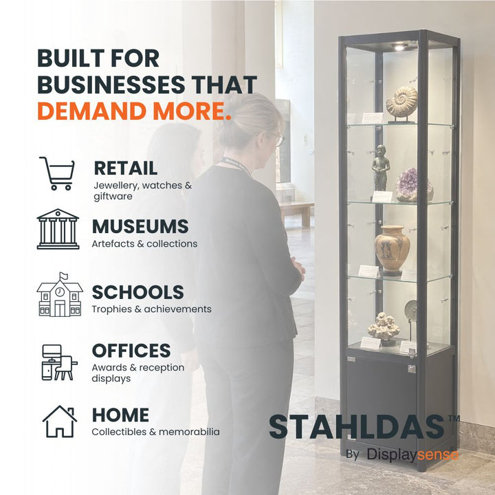 Black Stahldas glass display cabinet with LED lighting and lockable lower storage displaying museum artefacts in a gallery environment.