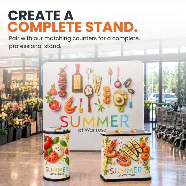 Straight tension fabric backdrop paired with matching branded exhibition counters to create a coordinated promotional stand.