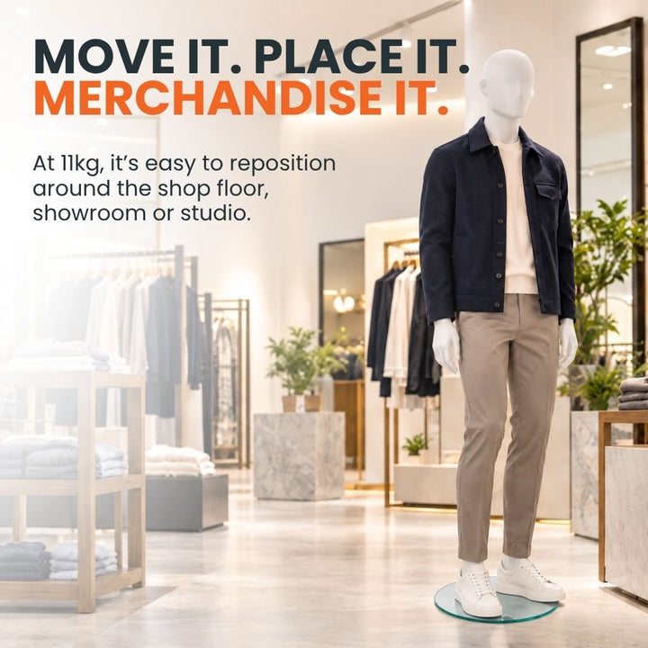 White full-body male mannequin dressed in casual clothing on a round glass base, positioned on a retail shop floor to demonstrate easy repositioning.