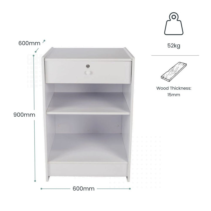 Dimension guide for a white wooden retail till block showing 900mm height, 600mm width, 600mm depth, 52kg weight and 15mm wood thickness, with open shelving and lockable drawer storage for POS equipment, bags, till rolls and shop supplies.