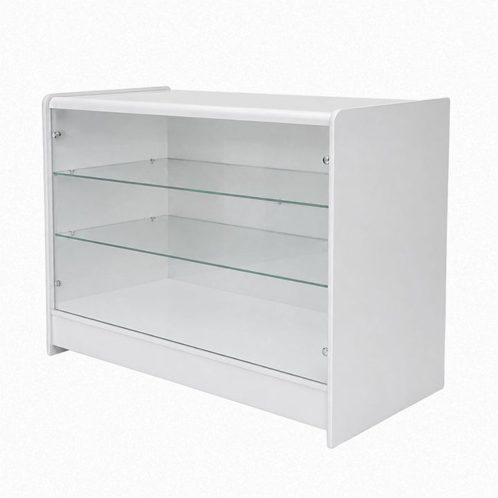 Angled product view of a white wooden glass retail counter with transparent front panels, two internal glass shelves and solid white side panels, ideal for creating a bright customer-facing product display in retail stores, showrooms, salons and high-street shop environments.