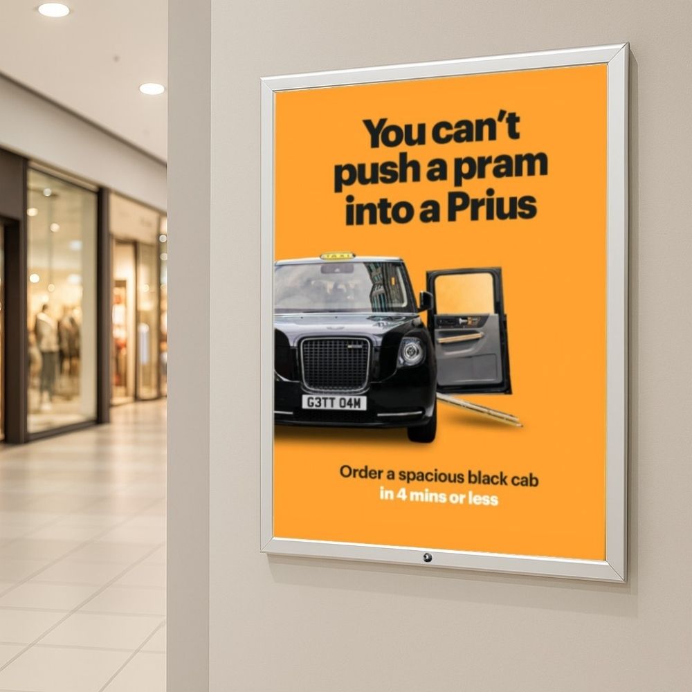 A1 lockable silver aluminium poster snap frame with a 32mm mitred frame, includes wall fixings for secure mounting.
