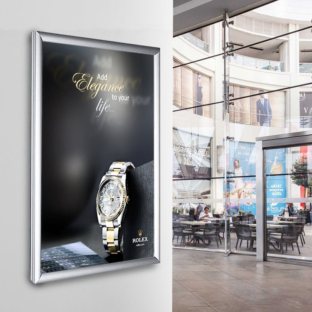 A sleek A1 silver LED light box snap frame with a 25mm mitred frame, designed for vibrant illuminated displays, complete with wall fixings for easy installation.
