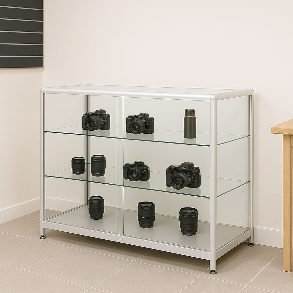 Sleek silver aluminium glass counter display cabinet with two shelves and lockable sliding doors, measuring 1200mm x 500mm.
